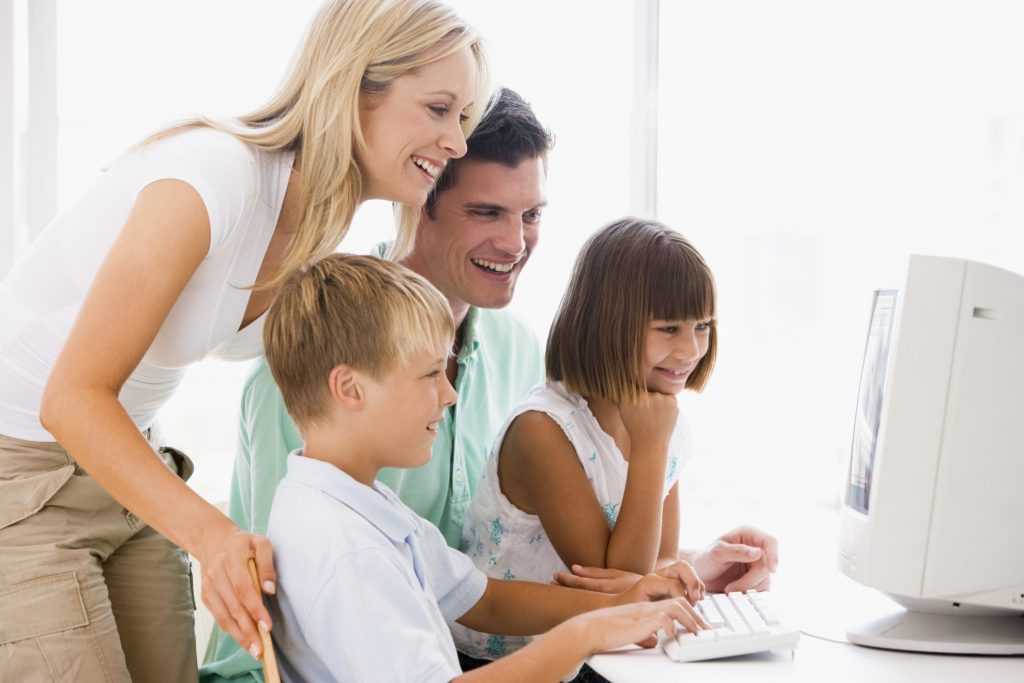 Family on computer together - Teaching Kids about money & Budgeting