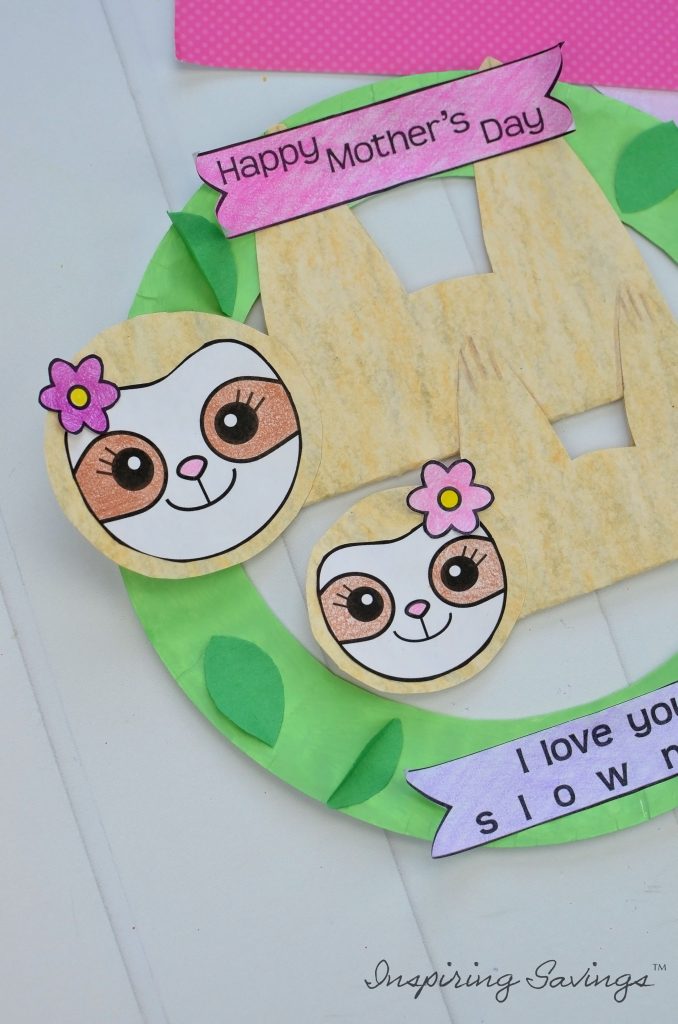 This is Heartwarming DIY Mother's Day card that your kids can actually make! A great craft to celebrate moms and grandmas! Sleepy Adorable Sloths pair perfectly with a homemade paper plate wreath. 