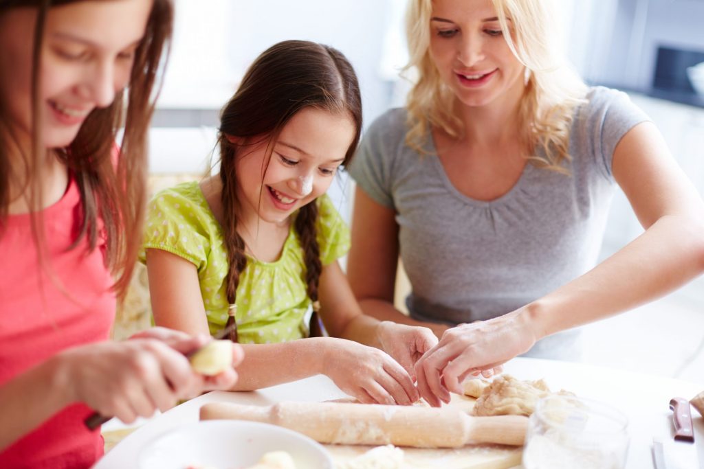 Women/daughters cooking dinner together - making pizza dough