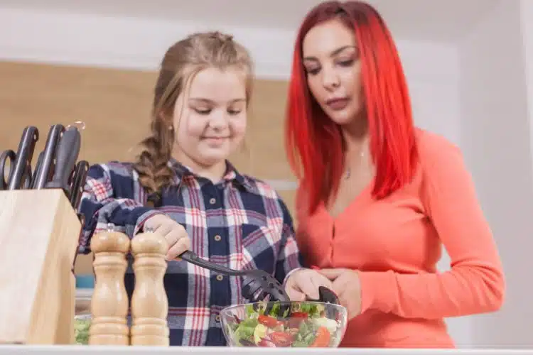 mor-dotter skära grönsaker