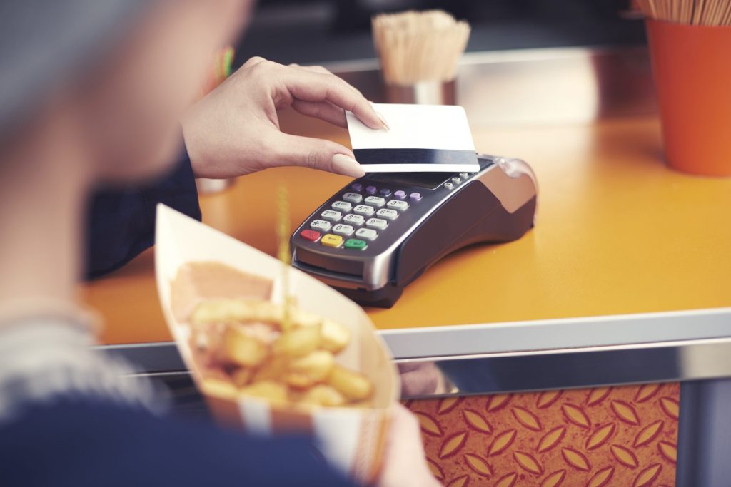 Woman paying for food with giftcard