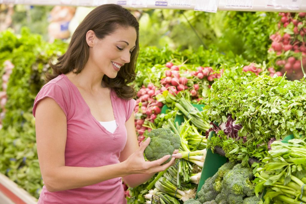 Woman shopping in produce section - coupon lingo