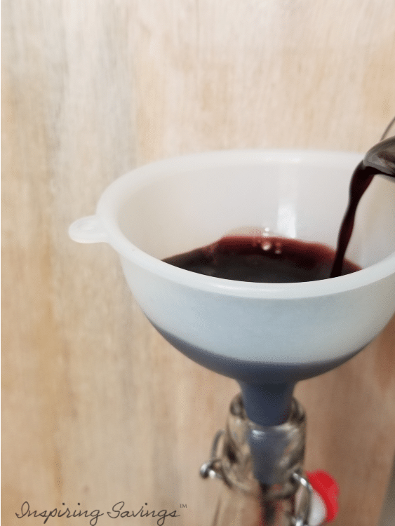 Bottling homemade elderberry syrup using funnel