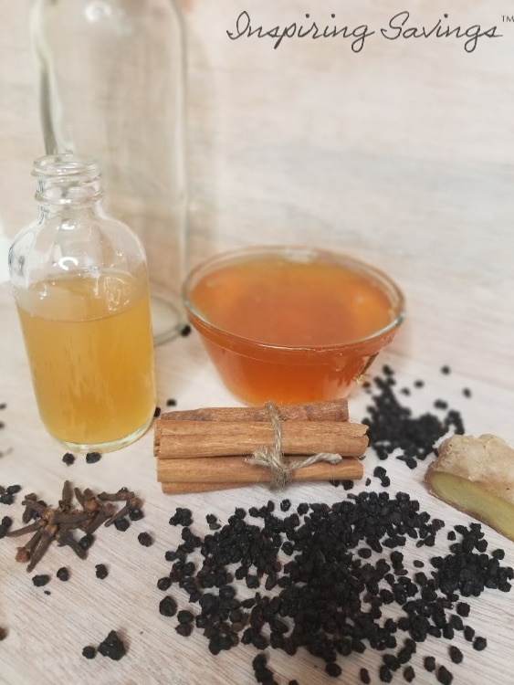 Ingredients needed for making homemade elderberry syrup on table