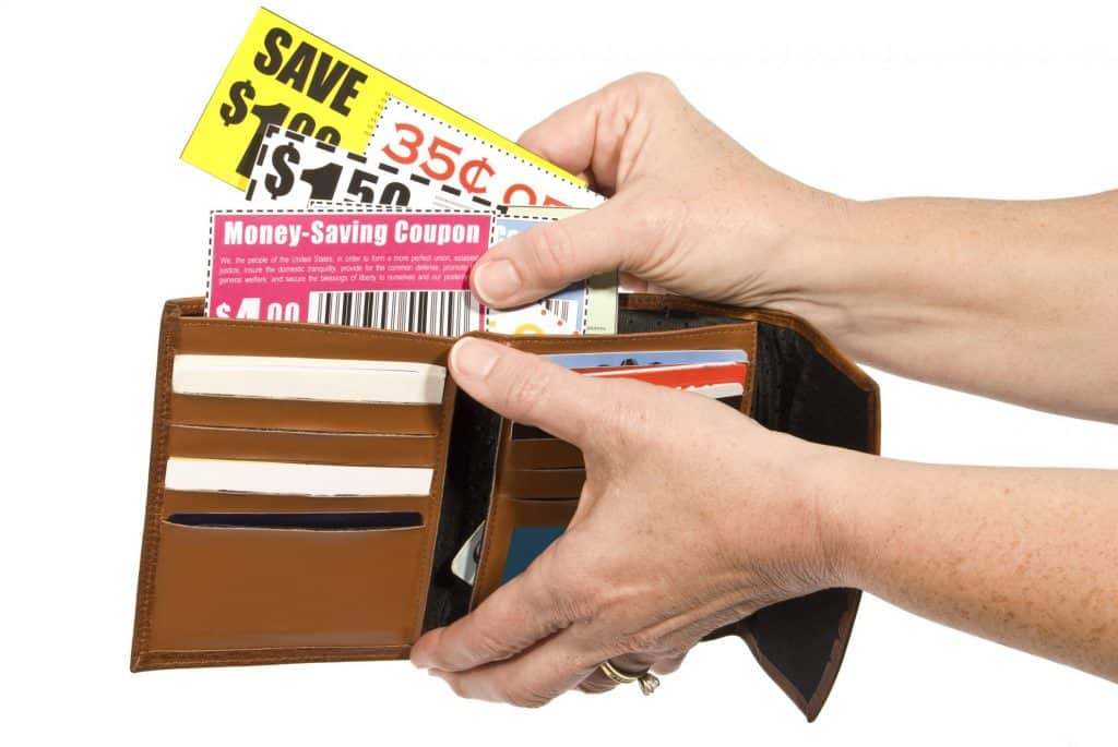 Woman pulling coupons out of a wallet