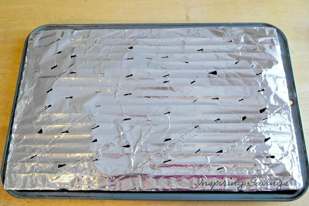 Baking tray with aluminum foil.  whole poked.