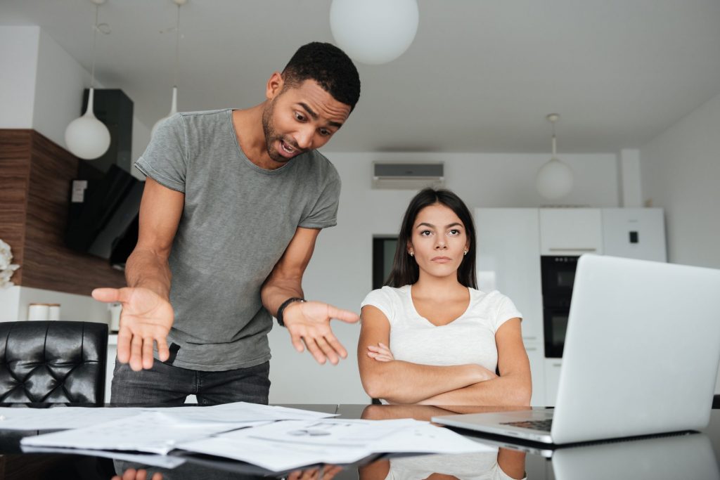 couple arguing over money -Mistakes Parents Must Avoid When Teaching Kids About Money