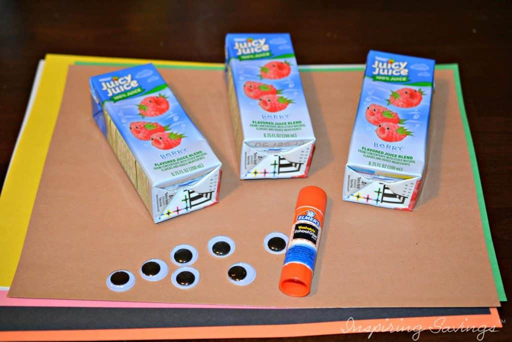 supplies for Turkey Juice Box Covers - pictured googly eyes, construction paper, glue sticks and juice boxes