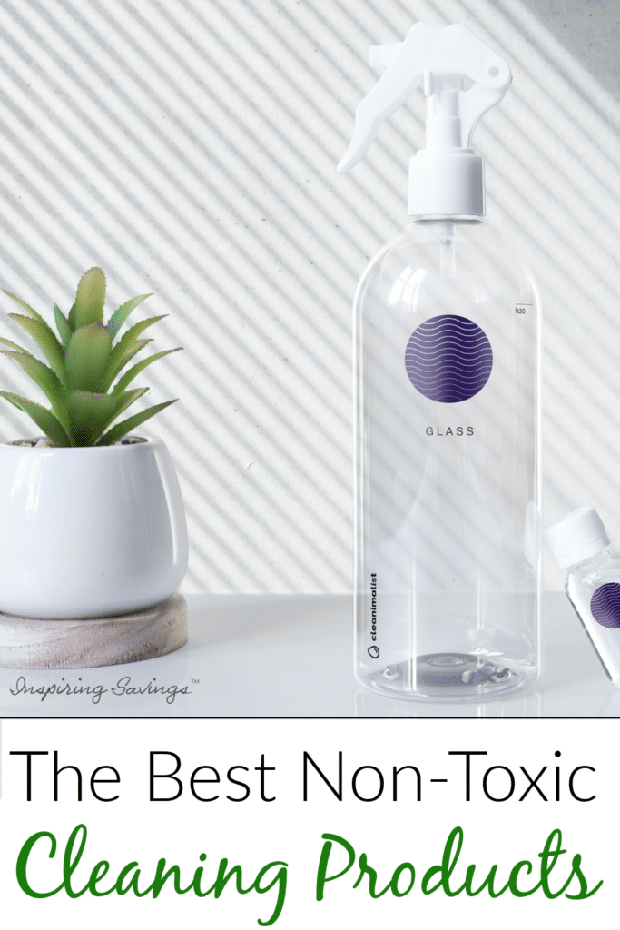 Clear cleaning bottle and plant on white table with text overlay - The Best Non-Toxic Cleaning Products