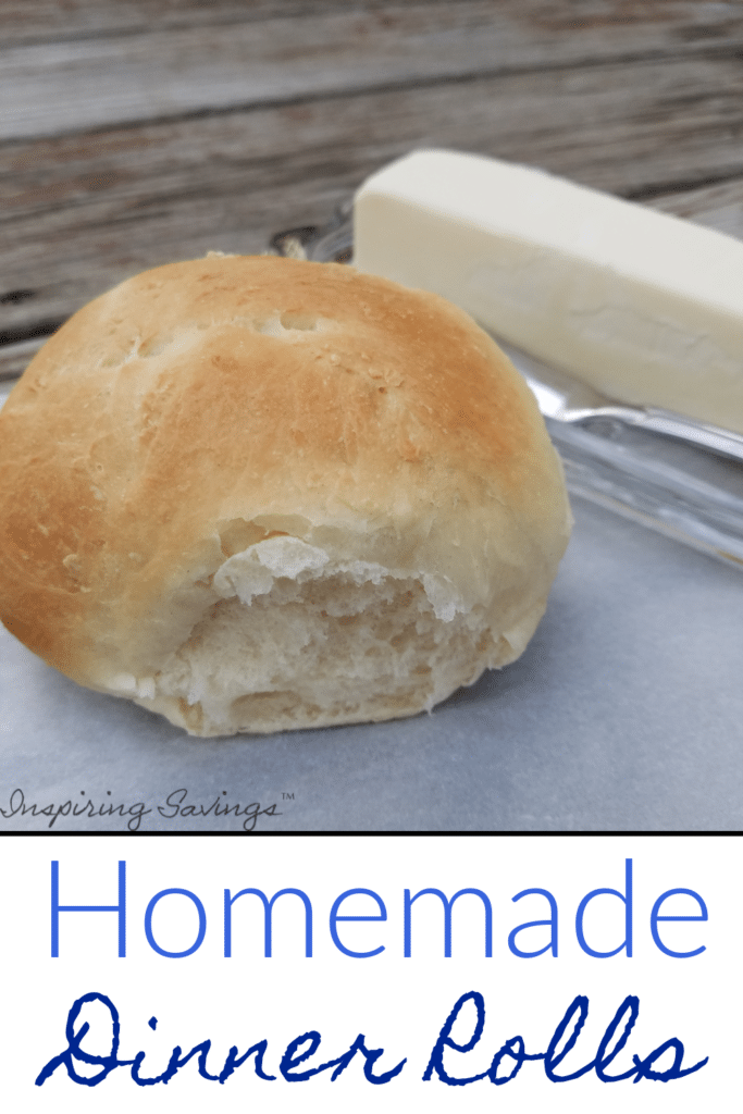 homemade dinner roll on parchment paper with a stick of butter