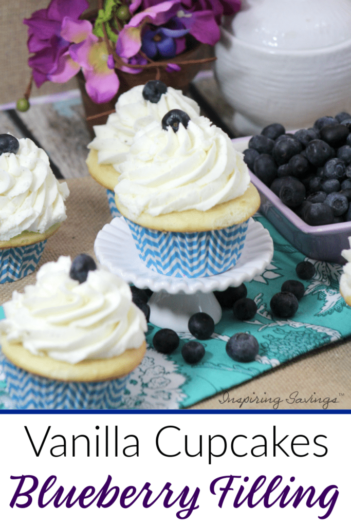 Vanilla Cupcakes with Fresh Blueberry Filling on table with purple flowers