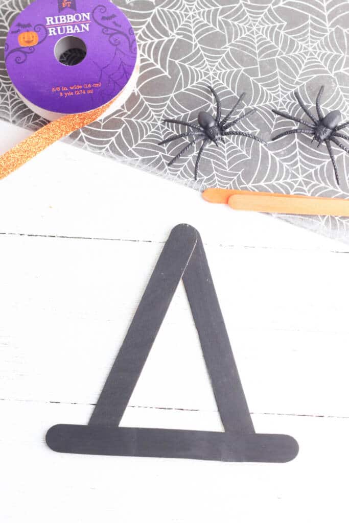 Forming witch's hat with black painted popsicle sticks