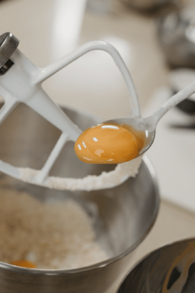 Slotted spoon separating eggs - spoon holding egg yolk