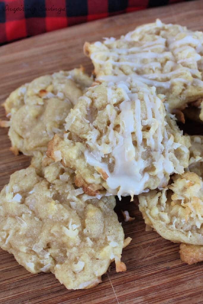 Baked Coconut Cookies stacked on top of each other on cutting board