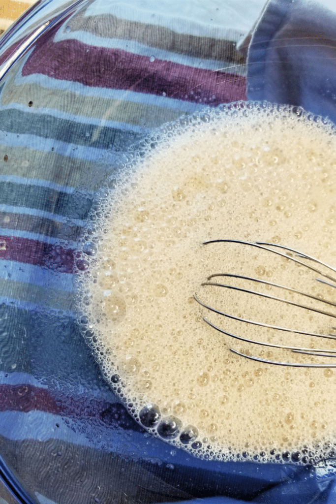 Mixing in wet ingredients using whisk in large bowl