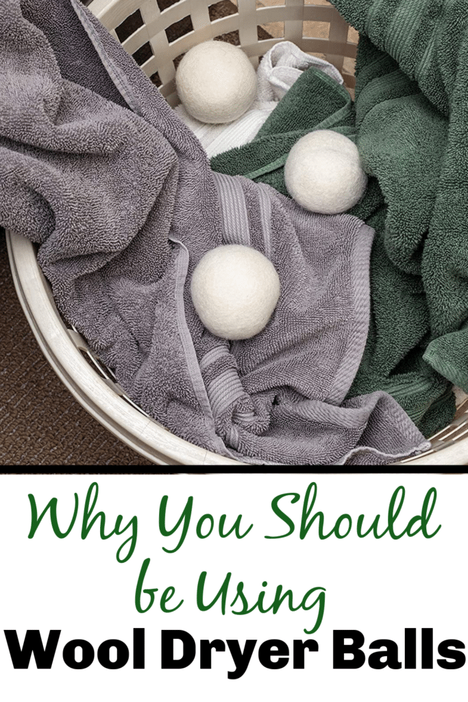 Why you should be using wool dryer balls - pictured three white wool dyer balls in laundry basket with towels