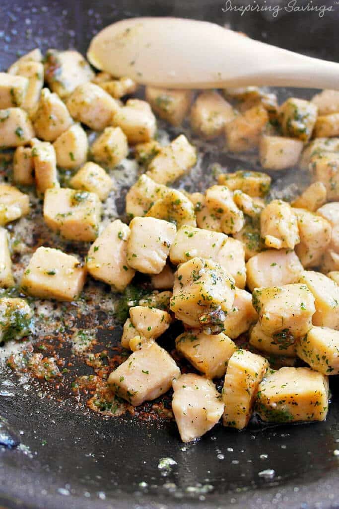 Adding spices to chicken in pan