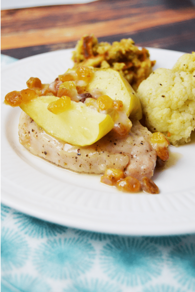 Apple Raisin Pork Chops on white dinner plate