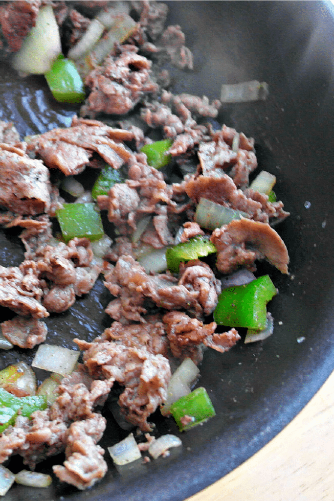 Browning meat in pan for steak and cheese wraps
