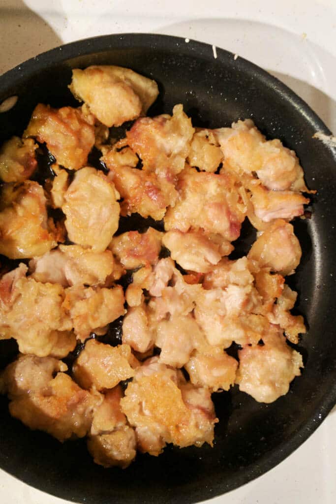 Cooking chicken for sweet and sour chicken in saute pan