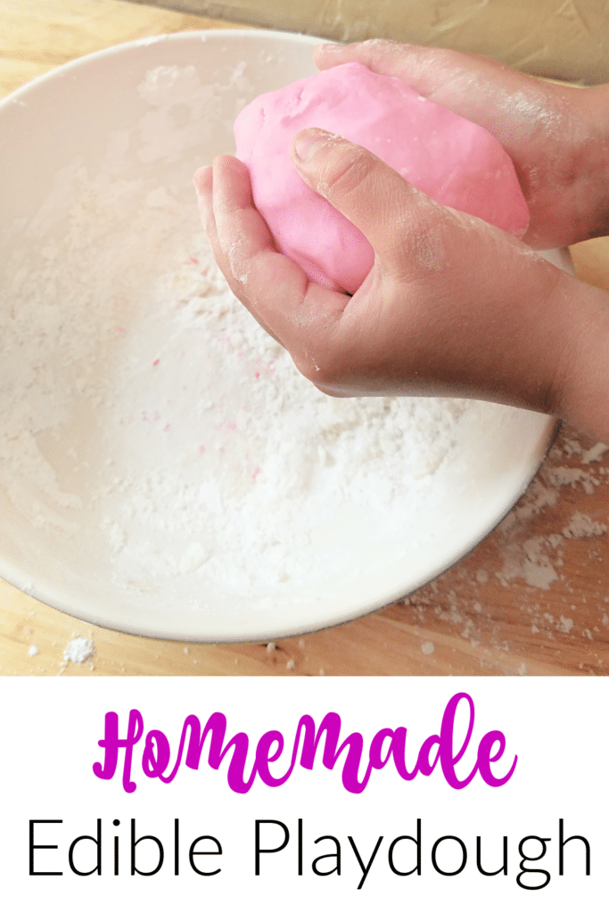 Homemade Edible Playdough Recipe - Child's hand playing with pink play dough. A great way to keep kids busy