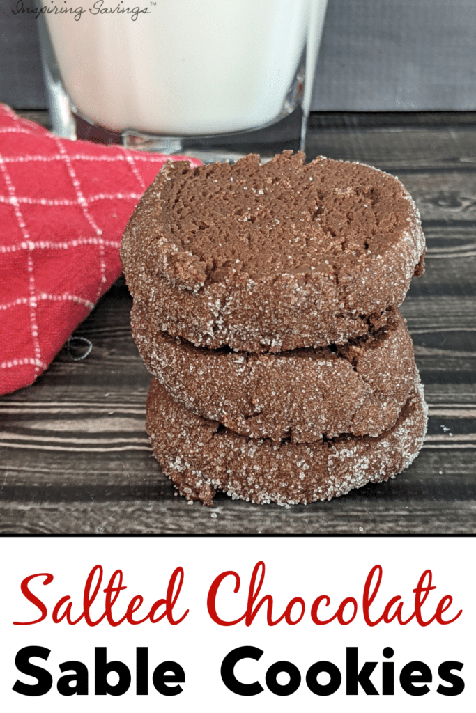 Salted Chocolate Sable Cookies stacked next to a glass of milk