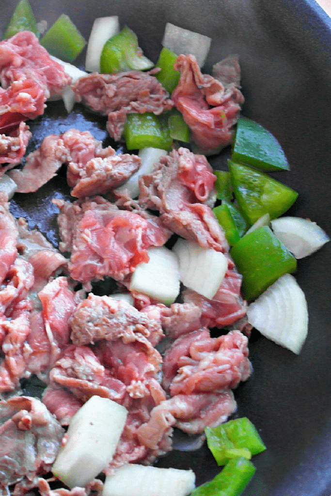 Steak and onions cooking