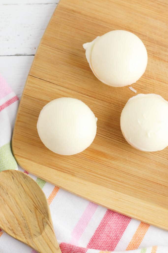 Creating hot cocoa bombs for spring - adding molded white chocolate cup to top