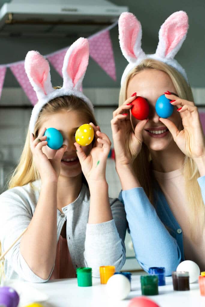 Easter basket gift ideas for tweens and teens - mom and daughter holding easter eggs up in front of eyes