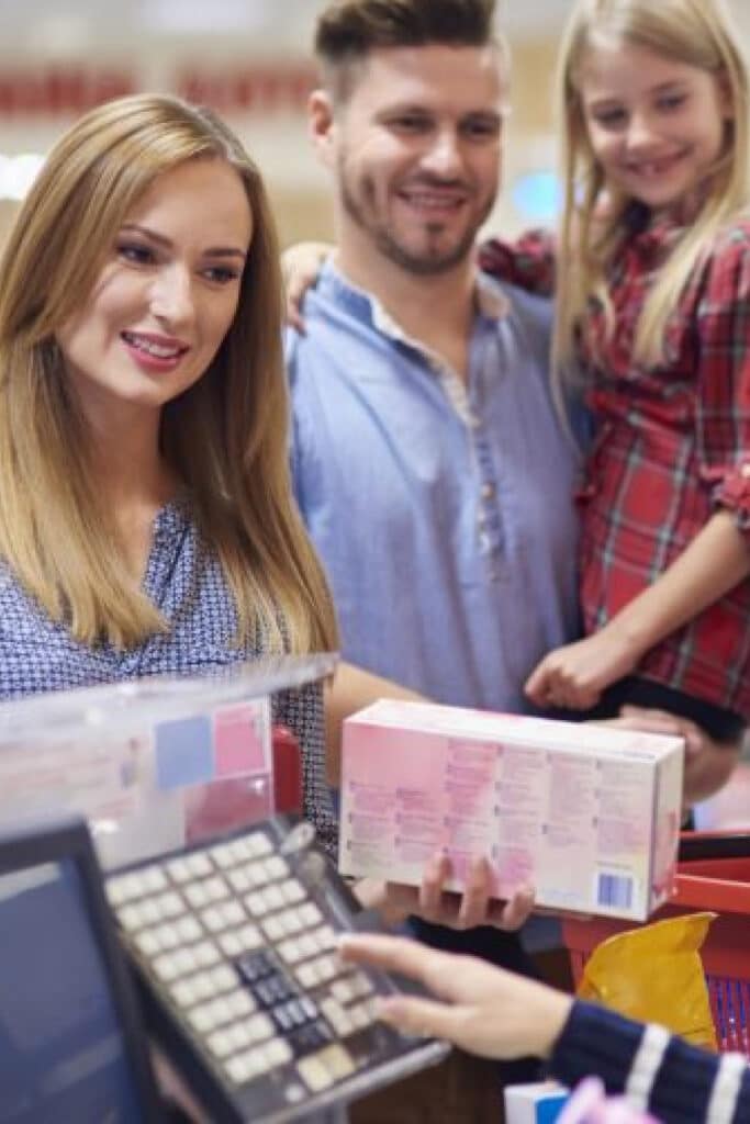 Family checking out at the grocery store. paying with cash