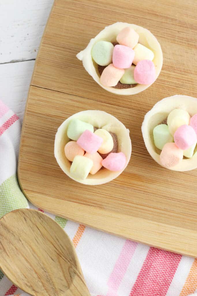 Filling molds with colorful mini marshmallows