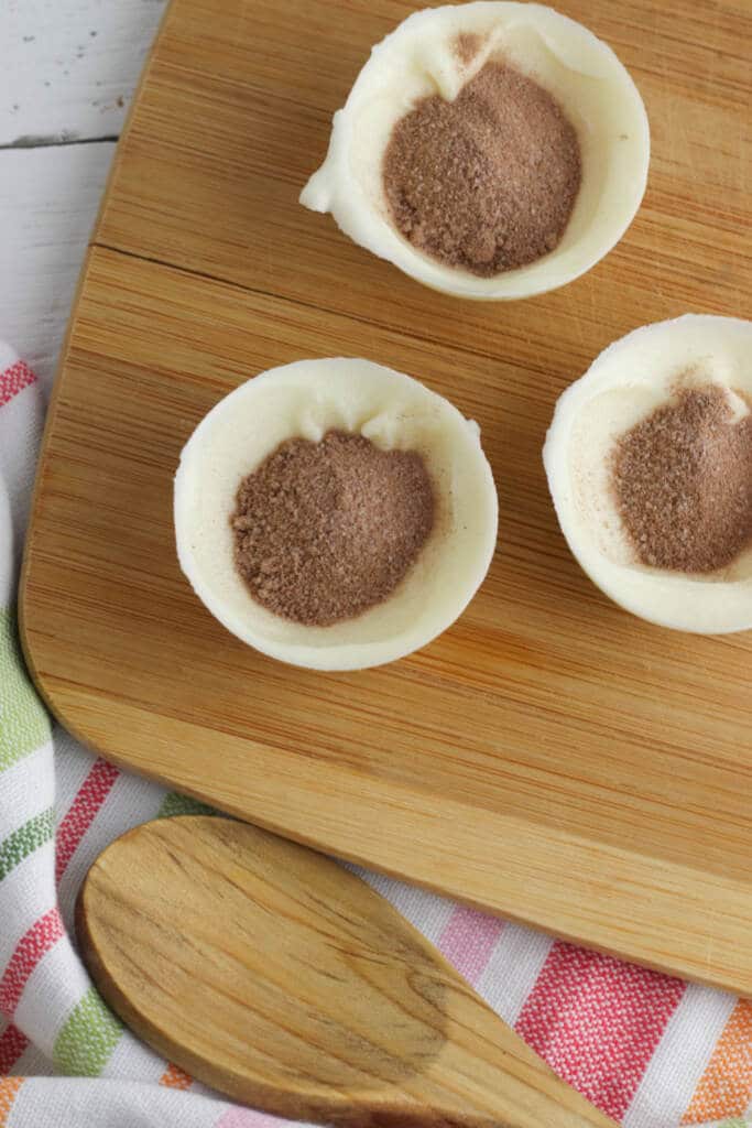 Filling molds with hot cocoa powder