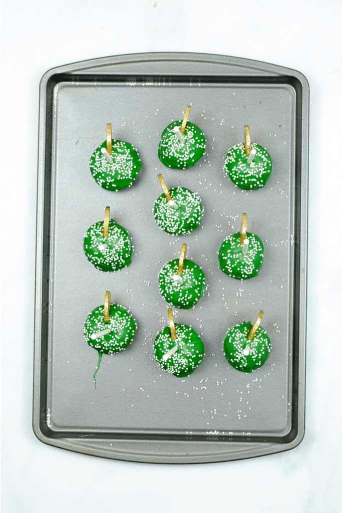 Finished St. Patricks Day cake pops on baking sheet