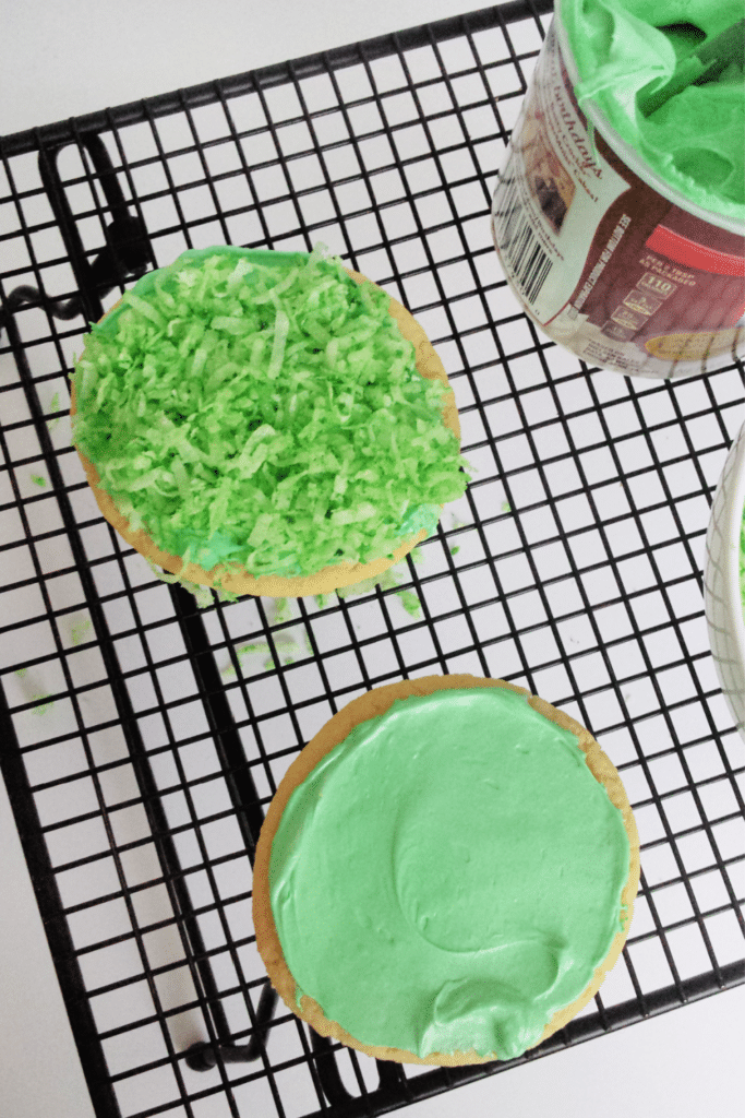 Frosting Cookies with green frosting on wire rack