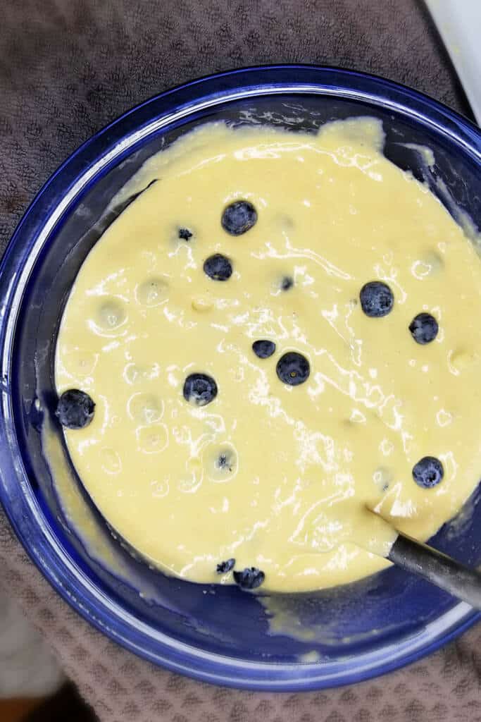 Mixing blueberries into batter