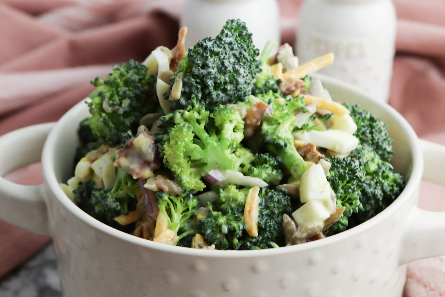 Vertical Broccoli Salad in white bowl