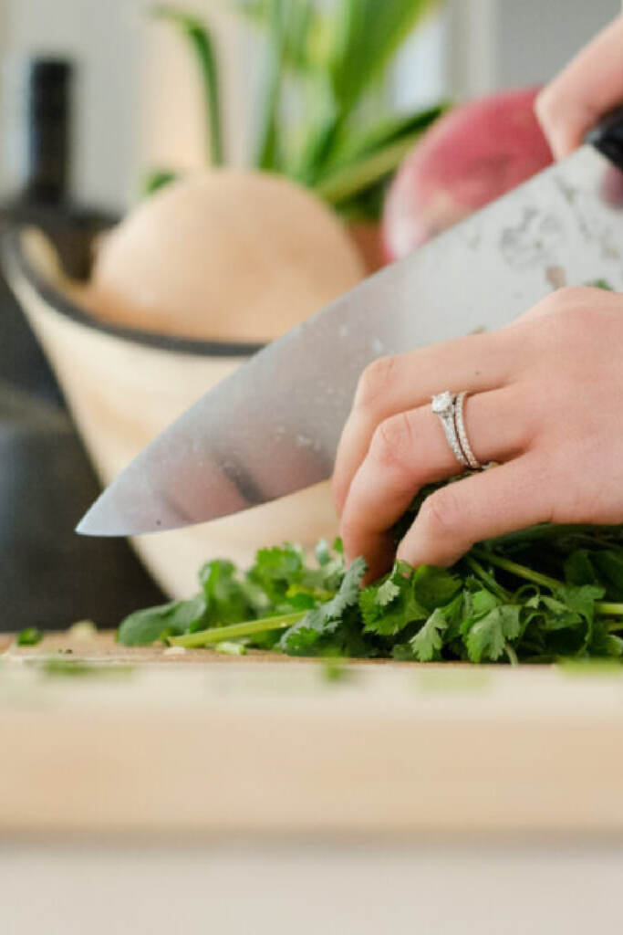 Freezer cook like a pro. woman chopping cilantro