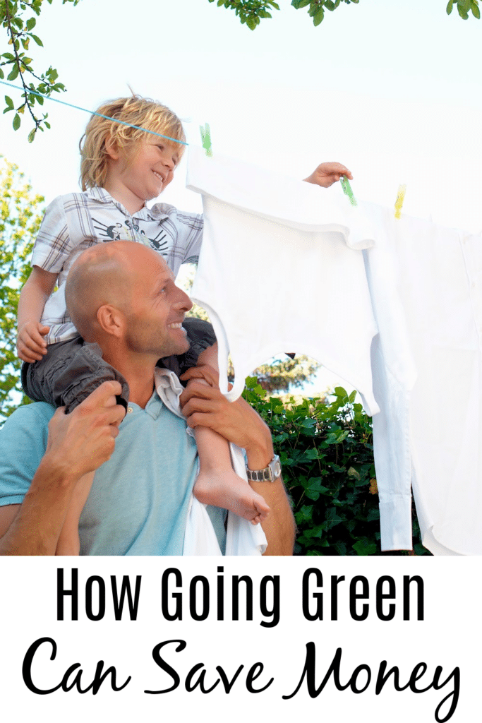 How Going Green Can Save Money - father son outside hanging up clothing on a clothing line