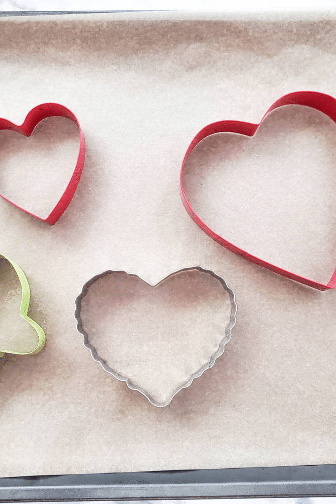 Prepping ornaments for birdseed - pictured different heart-shaped cookie cutters