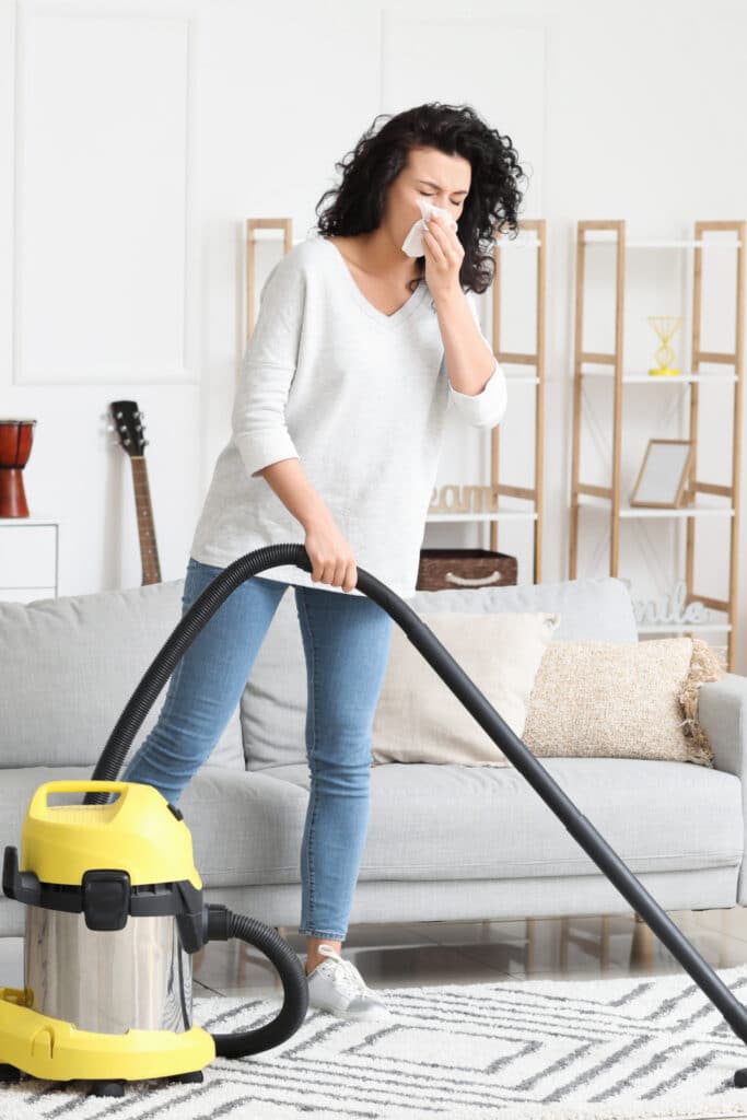 Women vacuuming home allergies