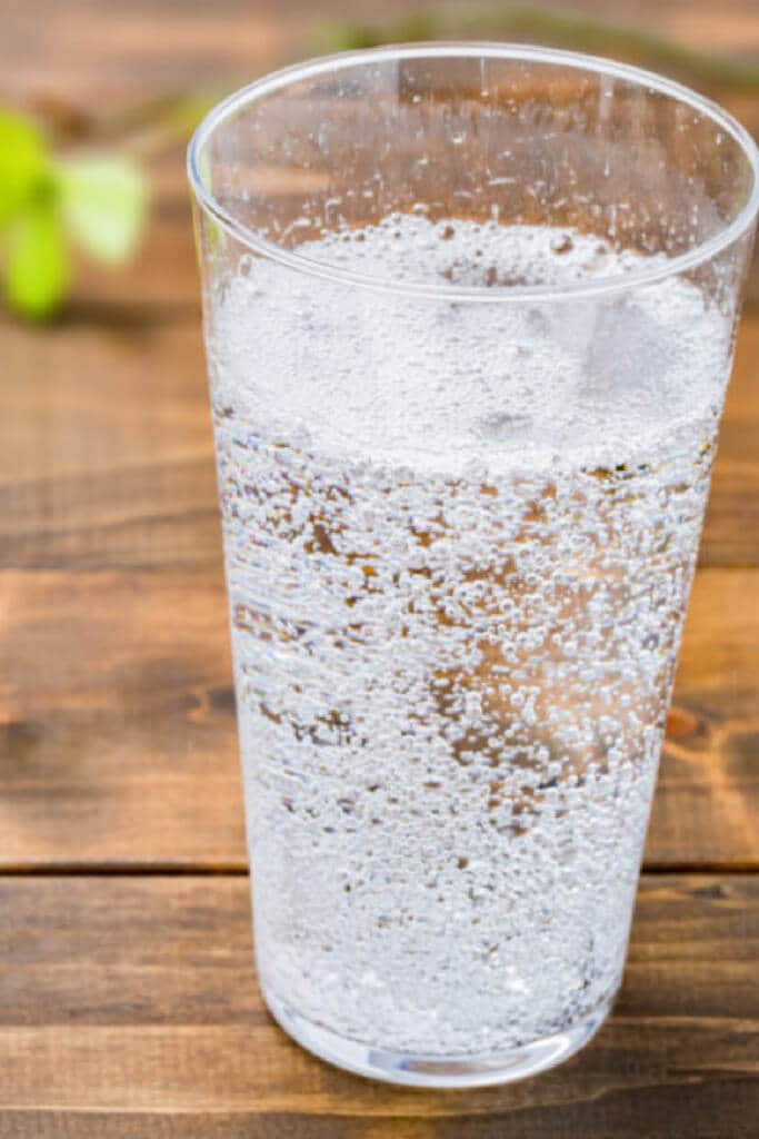 Alka Seltzer in clear glass cup - fizzy water to drink