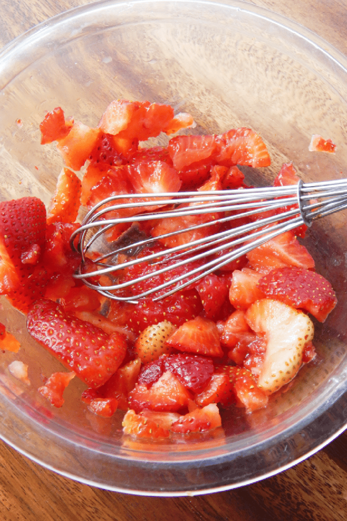 Crushed strawberries in glass bowl for dip