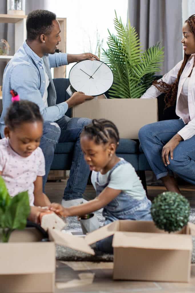 Family packing boxes together for moving