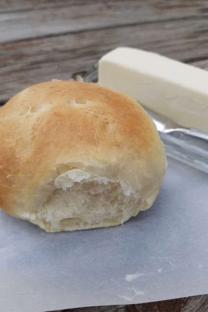 homemade dinner roll on parchment paper with unsalted butter