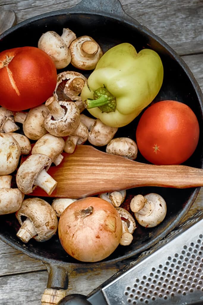 Food in pan meal planning - onions, peppers and mushrooms