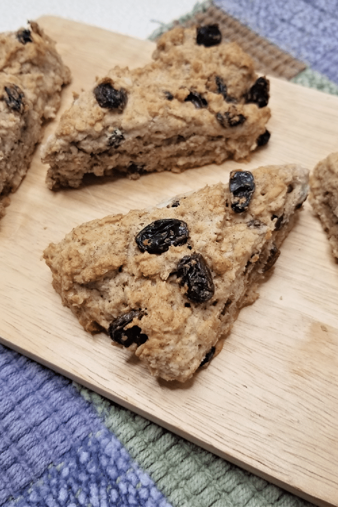 Healthy oatmeal scones on wooden cutting board after being baked in the oven.