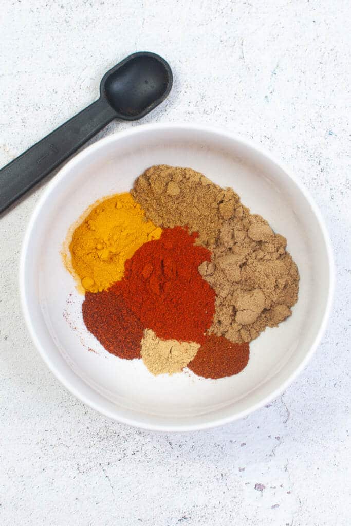 spices in white bowl to make curry powder