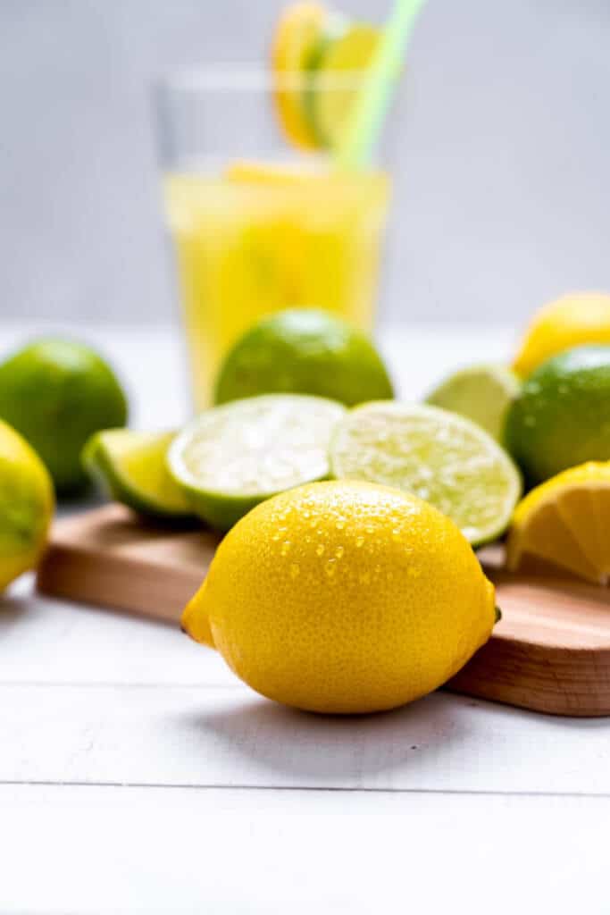 Whole lemon and limes, fresh fruit on cutting board