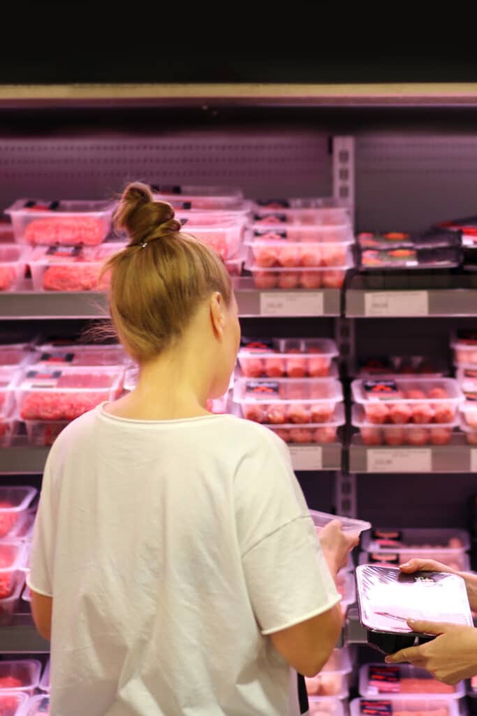 woman buying meat in family packs