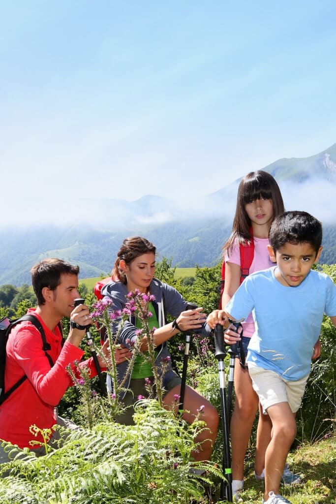 family together on top of mountain after hiking